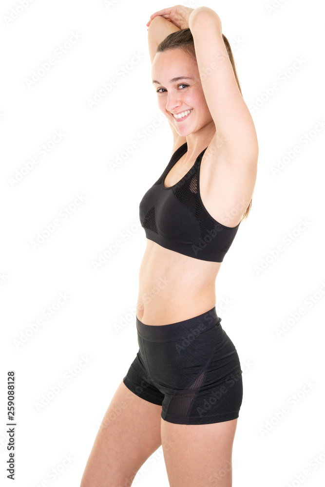Young sporty woman practicing doing exercise pose working out wearing sportswear black pants and top indoor in white sport studio Young sporty woman practicing doing exercise pose working out wearing sportswear black pants and top indoor in white sport studio