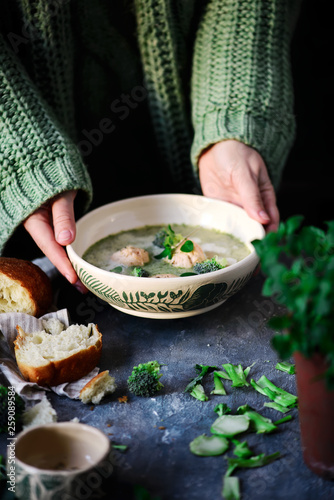 Broccoli  cream soup with salmon dumplings.selective focus photo