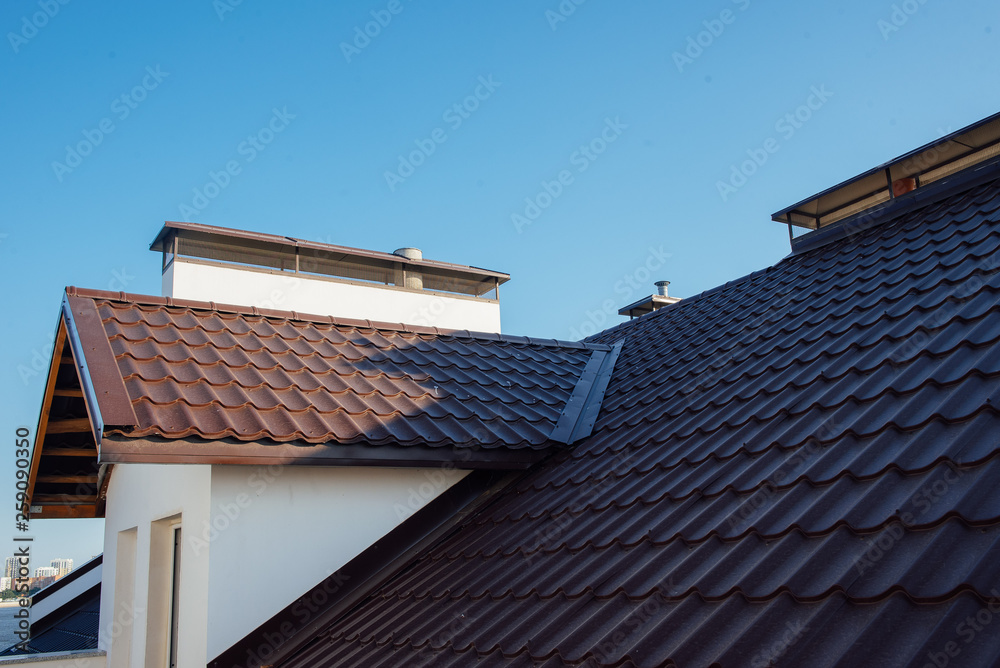 Tile Roof of a two-story white cottage