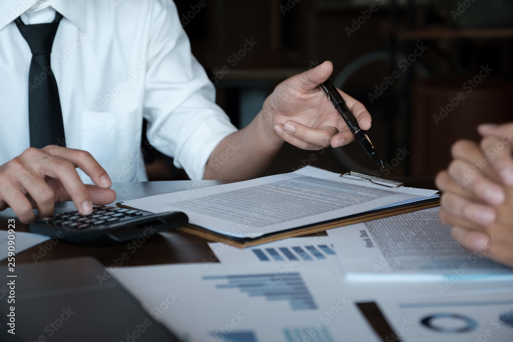 Naklejka premium Economic research discussions, Business team analyzing income charts and graphs to plan marketing concept with using calculator for analysis.