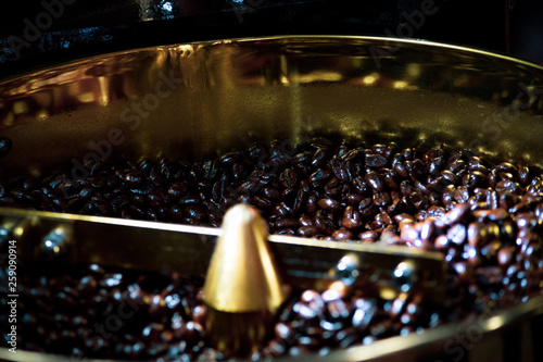 Roasted coffee in coffee roaster, Machine for roasting coffee bean roasting close up