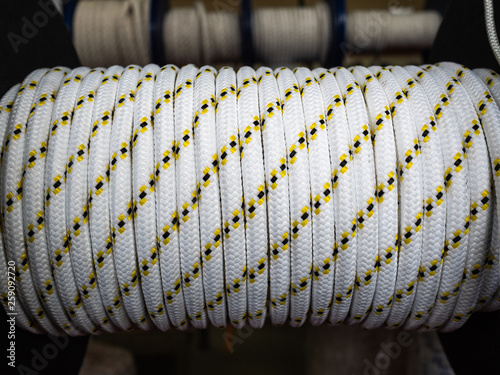 White rope on a show-window of shop. A safety rope for climbers. The rope is reeled up on the coil photo