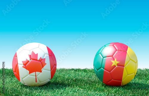 Two soccer balls in flags colors on green grass. Canada and Cameroon. 3d image