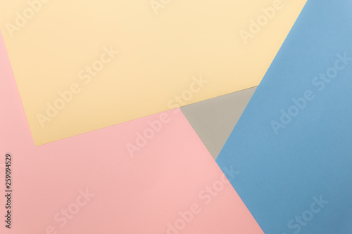 Multicolor background from cardboard of different colors. Pastel paper color for background. Colorful abstract geometric shapes. Pastel colored paper texture minimalism background. Pink, Blue, Grey.