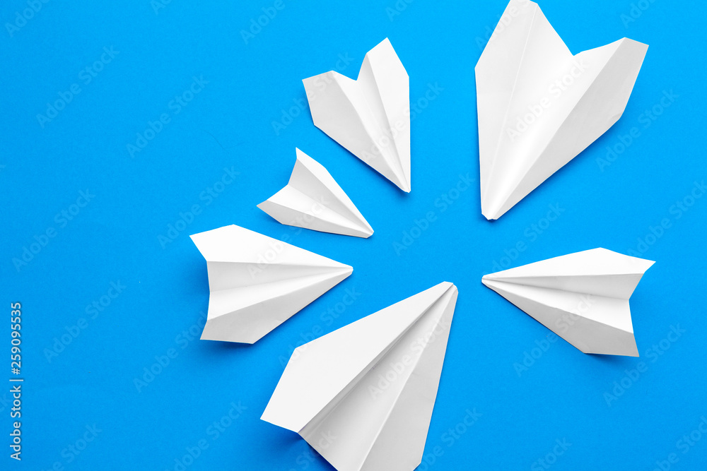 white paper airplane on a navy paper background white paper airplane on a navy paper background