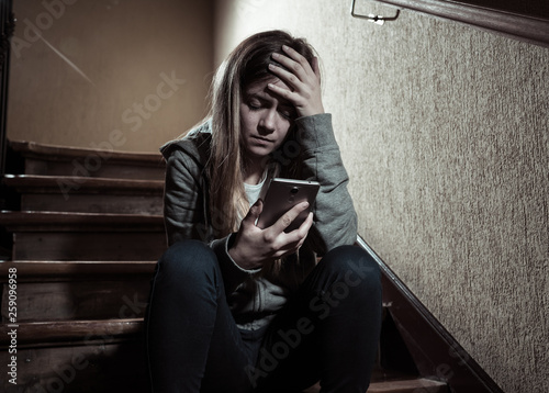 Bild auf Leinwand Beautiful lonely young girl depressed and worried suffering from bullying and ha