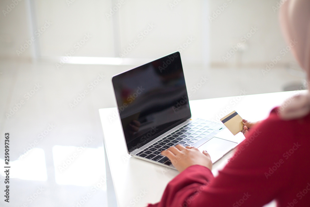Young beautiful asian Muslim woman working with computer Tablet blank screen and calculator Young beautiful asian Muslim woman working with computer Tablet blank screen and calculator