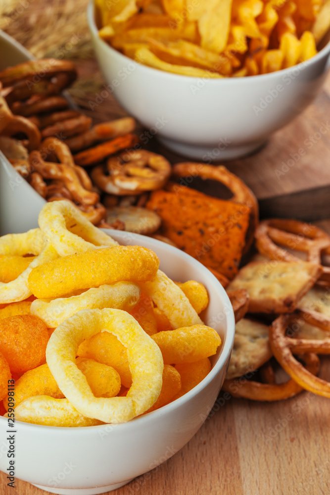Beer snacks on stone and wooden background. Top view, copy space Beer snacks on stone and wooden background. Top view, copy space