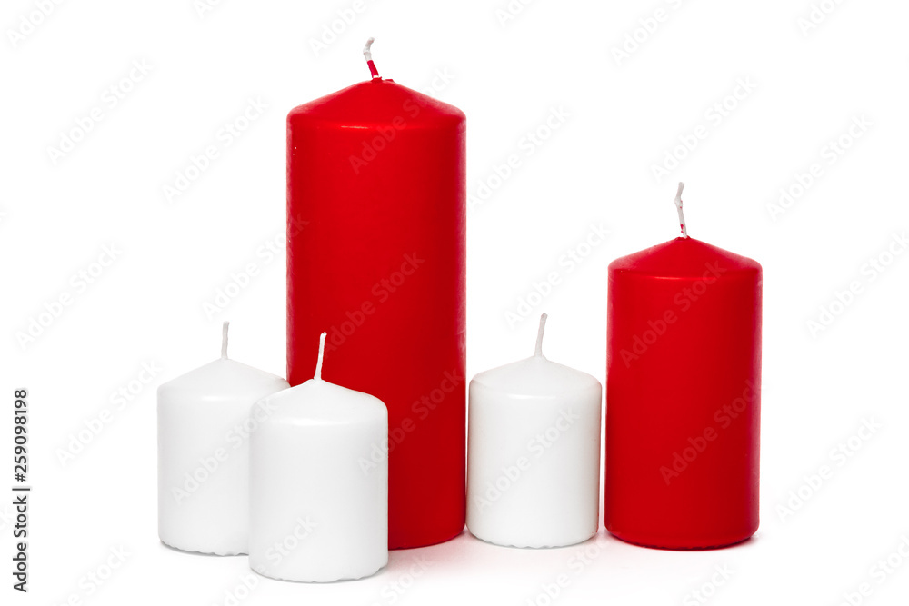 Red and white colored xmas candles isolated on white background Red and white colored xmas candles isolated on white background