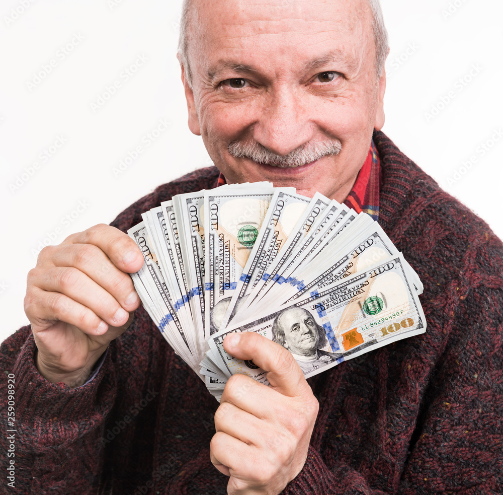 Senior man holding a stack of money. Portrait of an excited old businessman