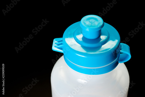 Plastic transparent bottle with blue cap for cycling and fitness.