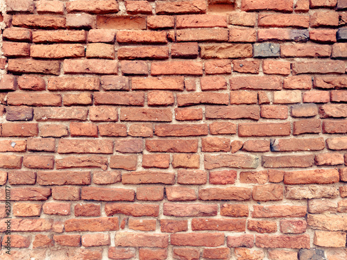 the old wall of red brick destroyed by wind and water