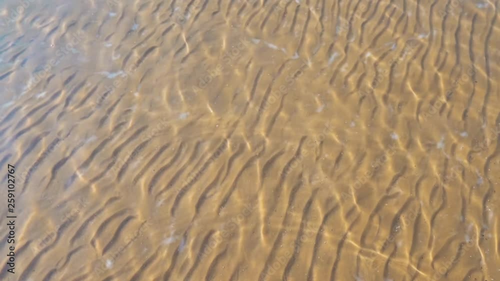 Transparent seabed. Sand and salt of the dead sea. Ripples on the surface of the water. Transparent seabed. Sand and salt of the dead sea. Ripples on the surface of the water.