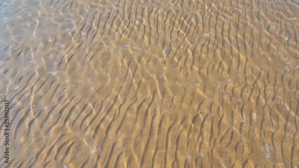 Transparent seabed. Sand and salt of the dead sea. Ripples on the surface of the water. Transparent seabed. Sand and salt of the dead sea. Ripples on the surface of the water.