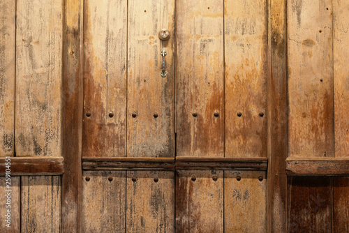 Old wooden planks use for texture and background..Close up of wooden door shopfront in old town market with evening light..