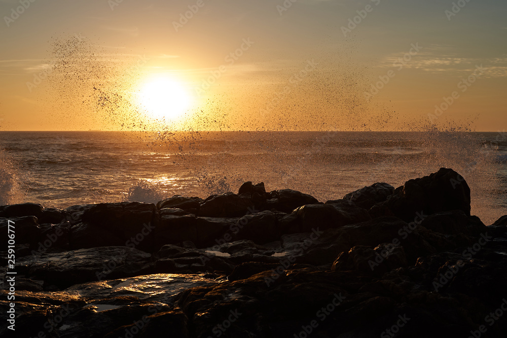 Sea sunset with crashing wave