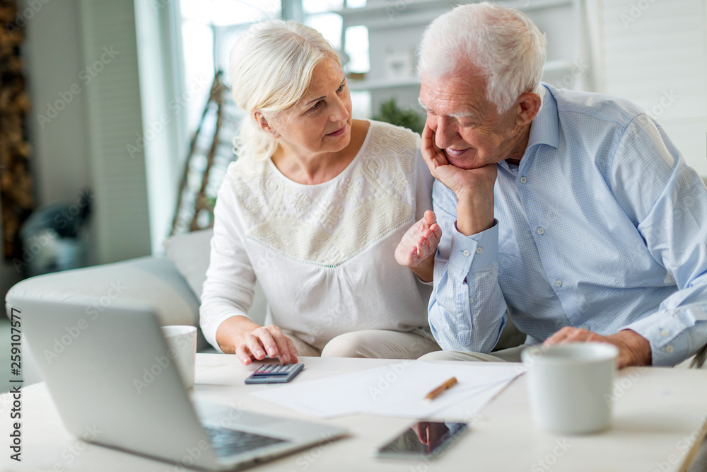 Senior couple using laptop computer at home Senior couple using laptop computer at home