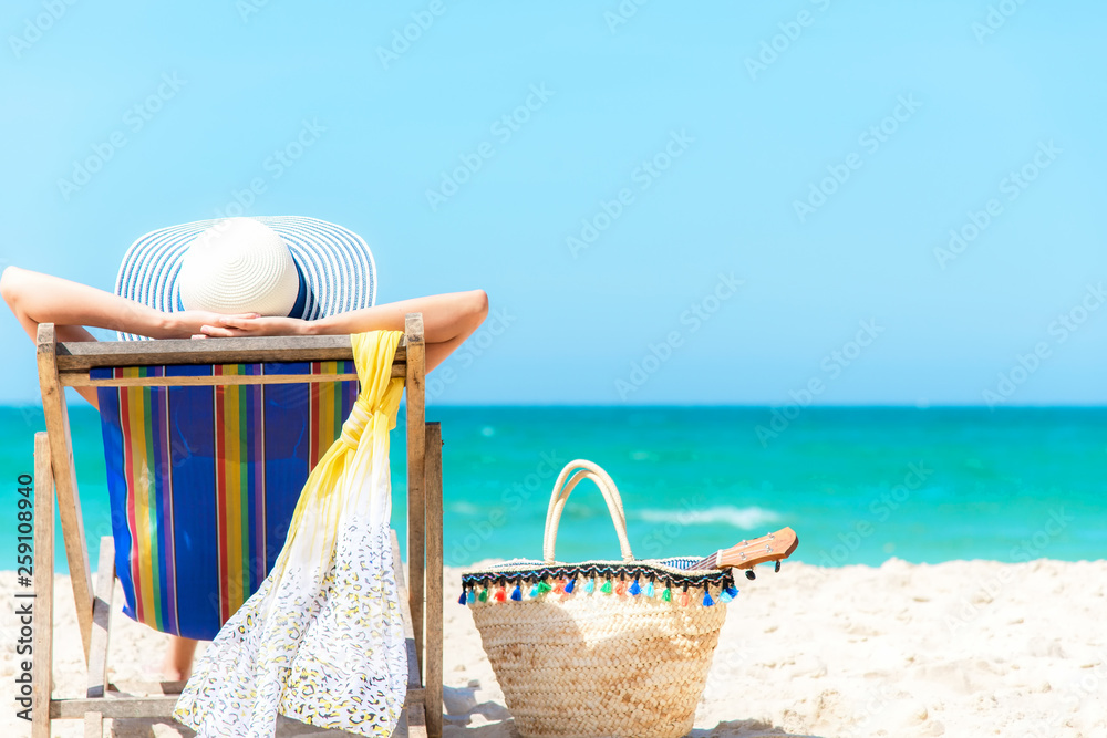 Summer Vacation. Asian lifestyle healthy woman relaxing and happy on beach  chair with cocktail coconut juice in holiday summer. Chill and Freedom  outdoor in the summertime. Travel lifestyle Concept. Stock Photo