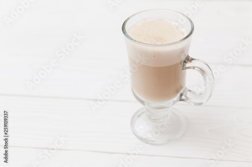 Raf coffee in transparent glass on a light wooden background. Delicious Russian most popular drinks. 