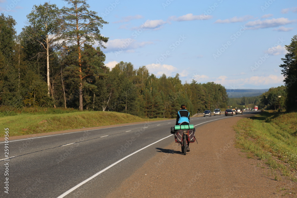 Fototapeta premium man riding a bike on country road