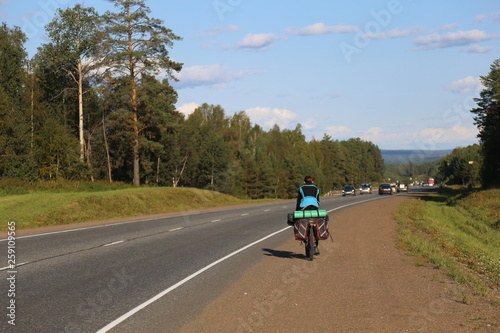 man riding a bike on country road