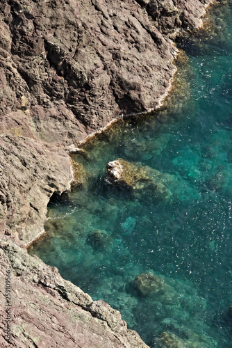 Cinque Terre, Liguria, Italy. Rocks overlooking the blue sea. The sea coast of the Five Lands with rock walls and rocks