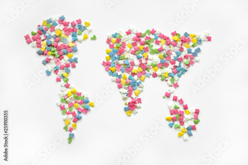 Colorful sugar sprinkles in world map shap on a white backgrounde  top view. Creative collection