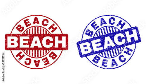 Grunge BEACH round stamp seals isolated on a white background. Round seals with grunge texture in red and blue colors. Vector rubber imprint of BEACH caption inside circle form with stripes.