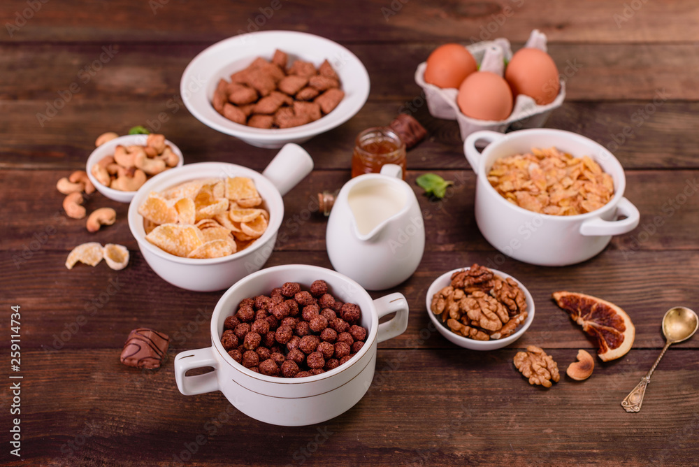 Tasty and useful breakfast with flakes, milk, nuts and dried fruits. The healthy food loading with energy Tasty and useful breakfast with flakes, milk, nuts and dried fruits. The healthy food loading with energy