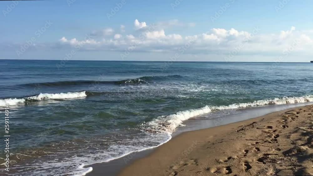 Tropical beach video showing blue foaming sea waves crushing against the coast line of Greece in the soft evening sun (with Sound) Tropical beach video showing blue foaming sea waves crushing against the coast line of Greece in the soft evening sun (with Sound)