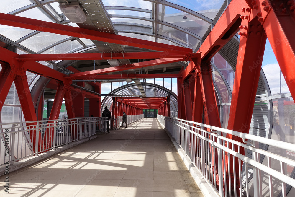 Overhead passage. Bolted steel beams. Painted in red. Interior.