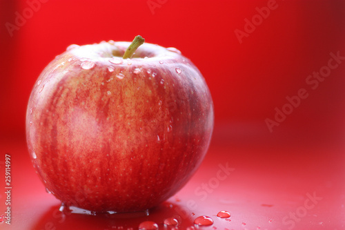 apple on red background, fresh and healthy