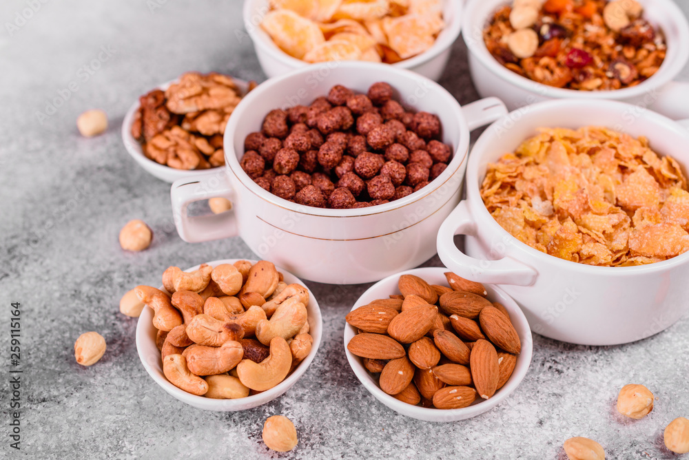 Tasty and useful breakfast with flakes, milk, nuts and dried fruits. The healthy food loading with energy Tasty and useful breakfast with flakes, milk, nuts and dried fruits. The healthy food loading with energy