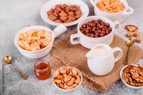 Tasty and useful breakfast with flakes, milk, nuts and dried fruits. The healthy food loading with energy