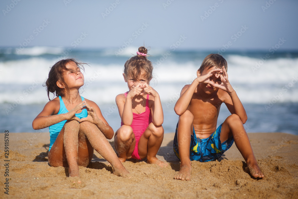 Three children rest on the sea summer of happiness Three children rest on the sea summer of happiness