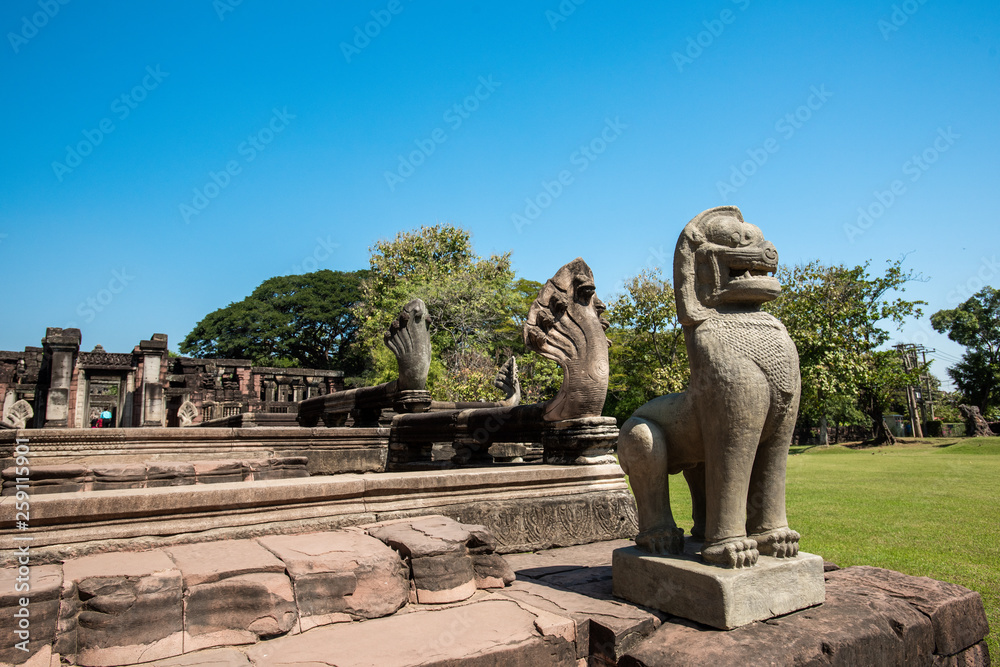 Lion sandstone statue in Phimai historical park and ancient castle in Nakhon Ratchasima, Thailand.