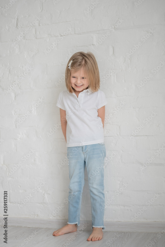 Full length of beautiful little girl in dress standing and posing over white background Full length of beautiful little girl in dress standing and posing over white background