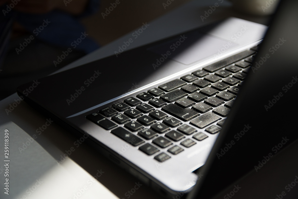 Laptop in Black and Silver Color with Reflection. Close Up concept