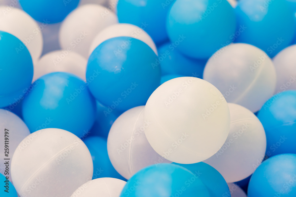 Close up of plastic white and blue balls in dry pool on the playground Close up of plastic white and blue balls in dry pool on the playground
