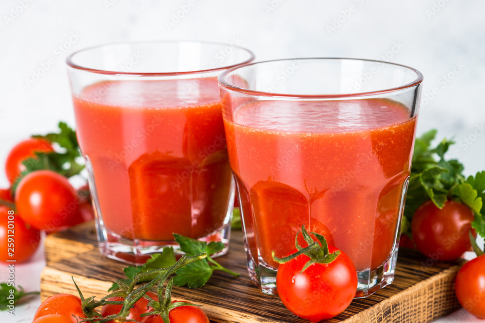 Tomato juice in glass on white. Tomato juice in glass on white.