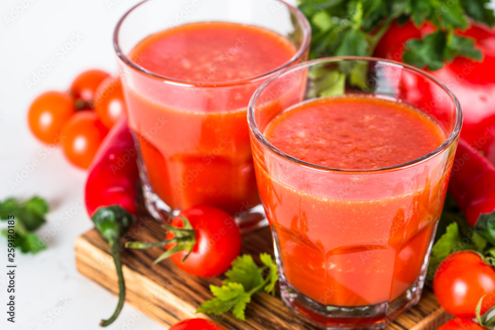 Tomato vegetable juice in glass on white. Tomato vegetable juice in glass on white.