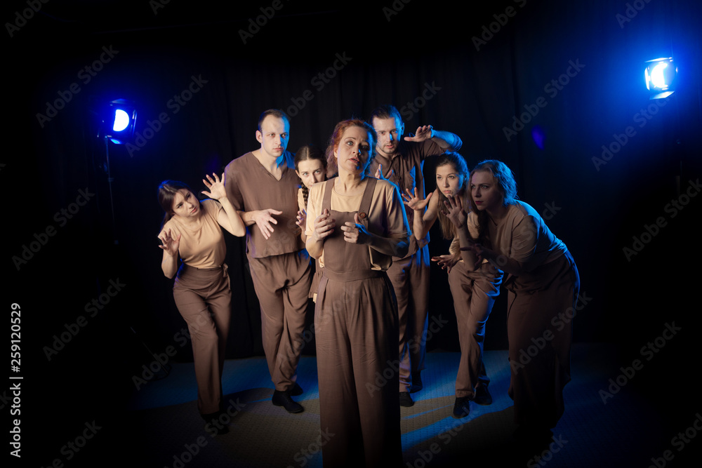 The actors on the stage play an emotion performance on a black ...