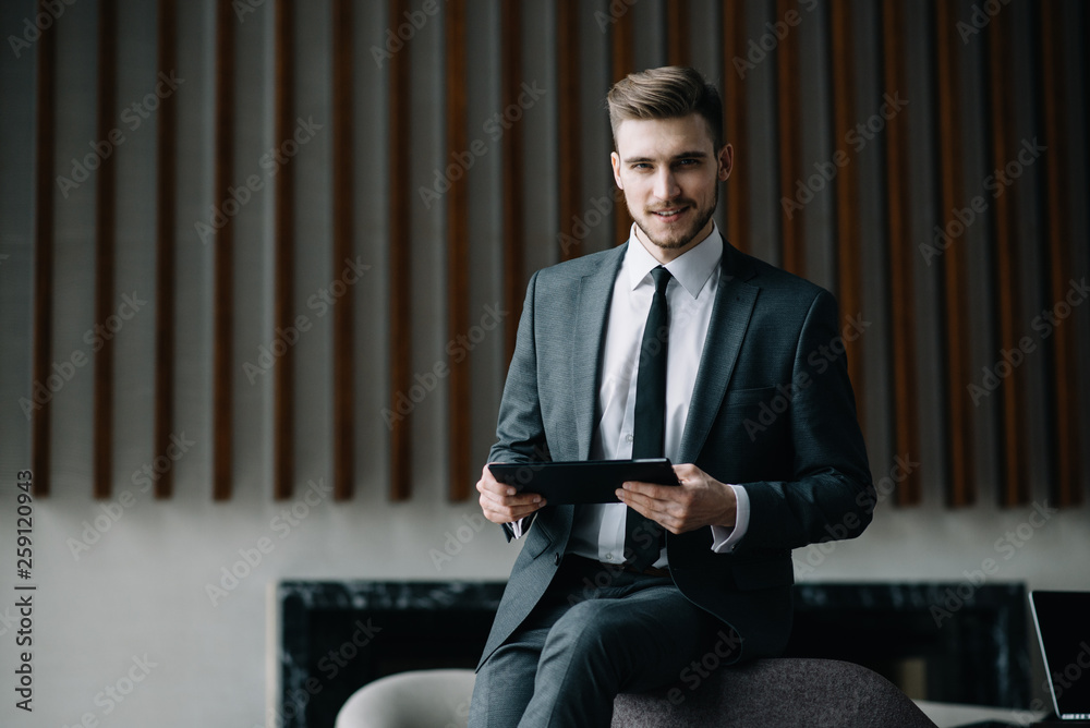 Young handsome businessman conducting negotiations with investors. Electronic business. Alternative payment services. Management of the projects on freelance. Cryptocurrency. Blockchain. Trader. Young handsome businessman conducting negotiations with investors. Electronic business. Alternative payment services. Management of the projects on freelance. Cryptocurrency. Blockchain. Trader.