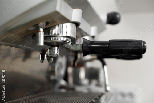 Stainless steel cooking appliance to brew coffee. Parts of coffee machine. Closeup coffee machine holder installed in machine