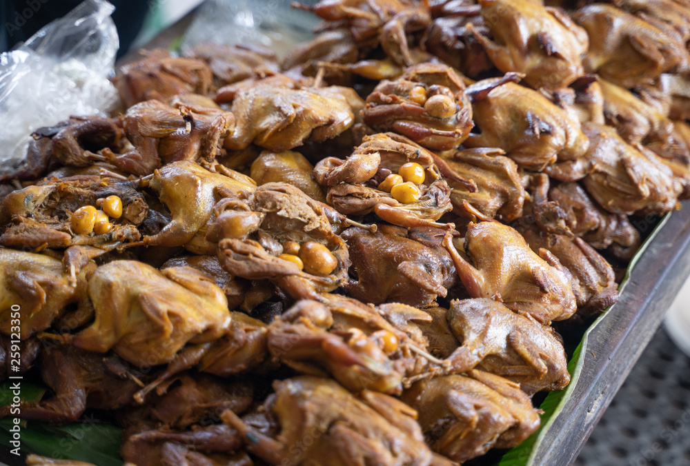 indonesian traditional food snack of grilled bacem quail chicken bird in the market