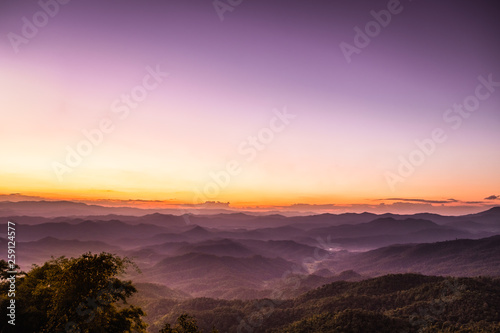 purple sky sunset with scenery beautiful romantic mountain hill and fog in Chiang Mai  © kitti