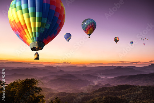 purple sky sunset hot air Colorful balloon flying with scenery beautiful romantic mountain hill and fog in Chiang Mai , Thailand.