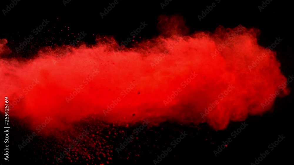 Super slowmotion shot of red powder explosion isolated on black background.