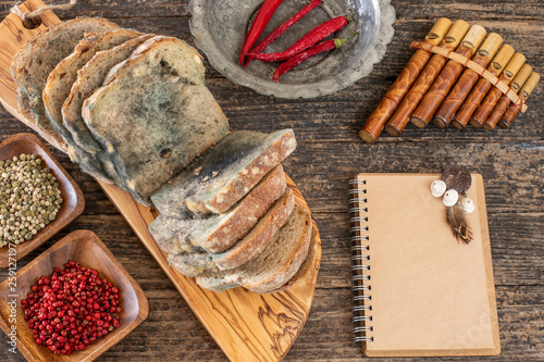 Moldy bread on the wooden rustic table , scarcity