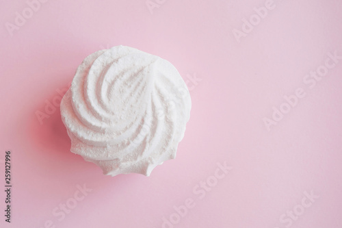  white lush fresh marshmallows on a bright pink monochrome background close-up with free space on the right
